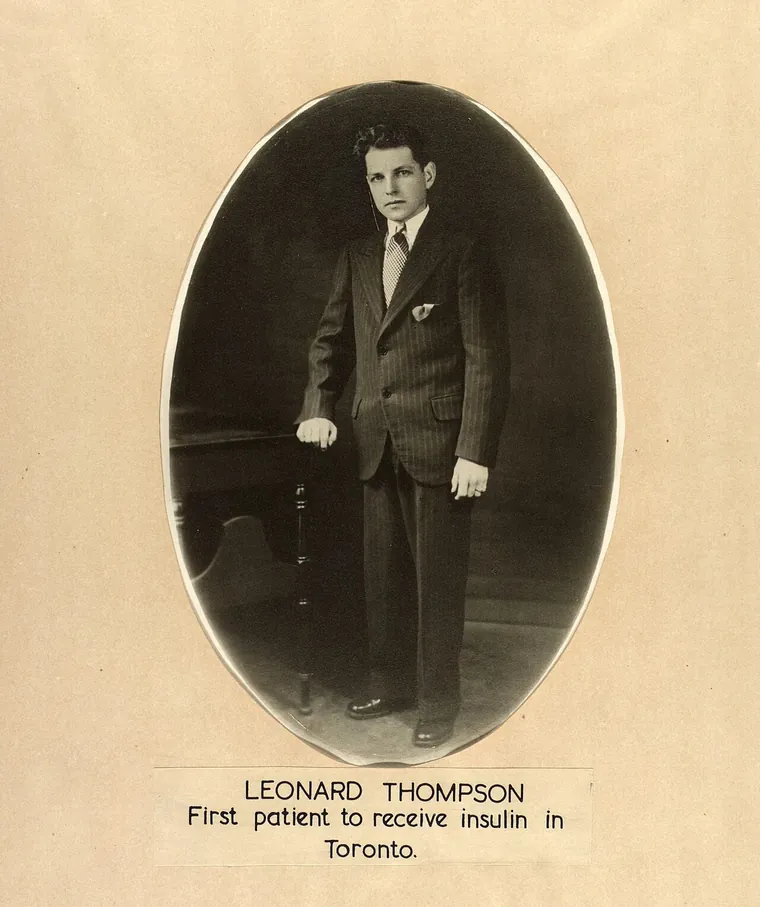 Studio portrait of Leonard Thompson, a young man in a suit, in an oval frame